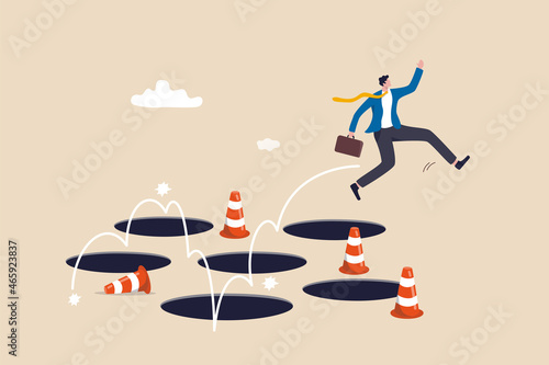 Canvas Print Avoid pitfall, adversity and brave to jump pass mistake or business failure, skill and creativity to solve problem concept, smart businessman jump pass many pitfalls to achieve business success