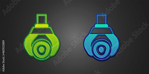 Green and blue Grapple crane grabbed a log icon isolated on black background. Forest industry. Industrial crane for lumber trunk wood production. Vector