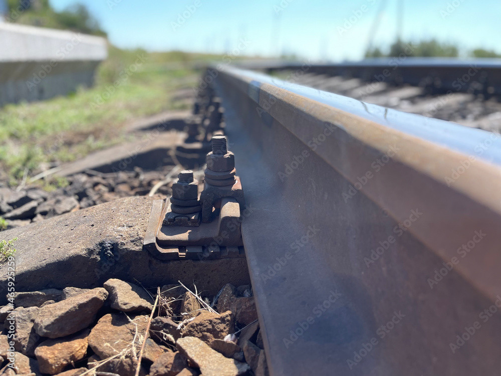 Special bolts hold steel rail on cement sleeper on ailway