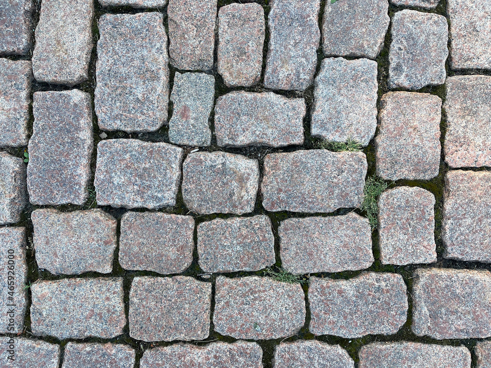 Granite paving stones on the city street - top view Granite paving stones on the city street - top view