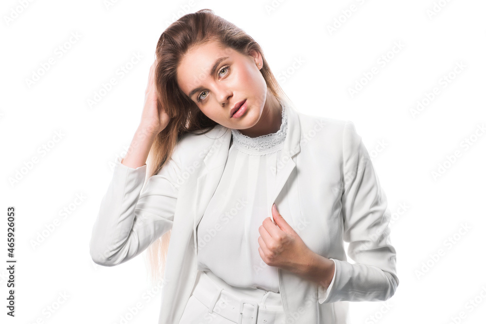 Woman straightens hair. Studio Portrait of Young Woman in a White Suit. Beauty Isolate Image Hairstyle Horizontal. Brown-haired Long Hair Female Looking Straight. Blurred Details. Woman straightens hair. Studio Portrait of Young Woman in a White Suit. Beauty Isolate Image Hairstyle Horizontal. Brown-haired Long Hair Female Looking Straight. Blurred Details.