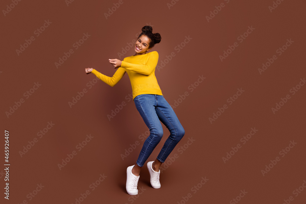 Full size photo of little girl dance wear pullover jeans footwear isolated on brown color background