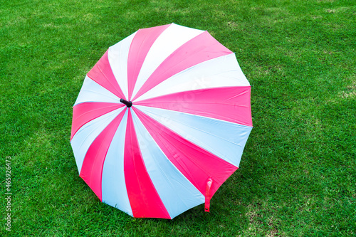 Colorful umbrella beach pattern on grass lawn background.