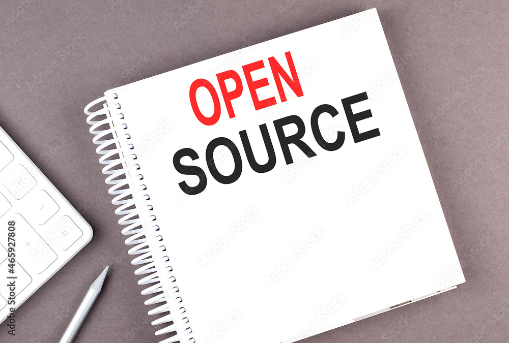 OPEN SOURCE text on notebook with calculator and pen,business concept OPEN SOURCE text on notebook with calculator and pen,business concept