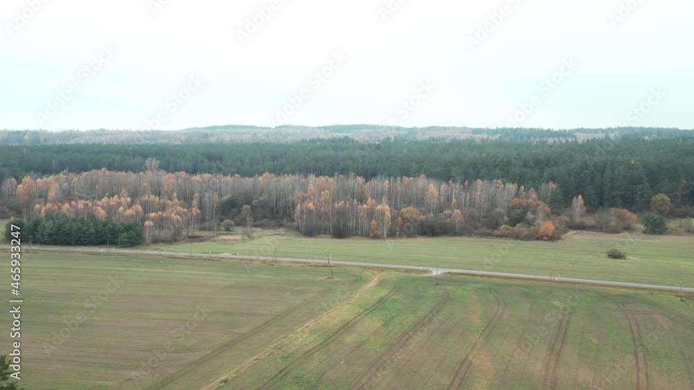 AERIAL: Plains with Forest and Empty Road in Background AERIAL: Plains with Forest and Empty Road in Background