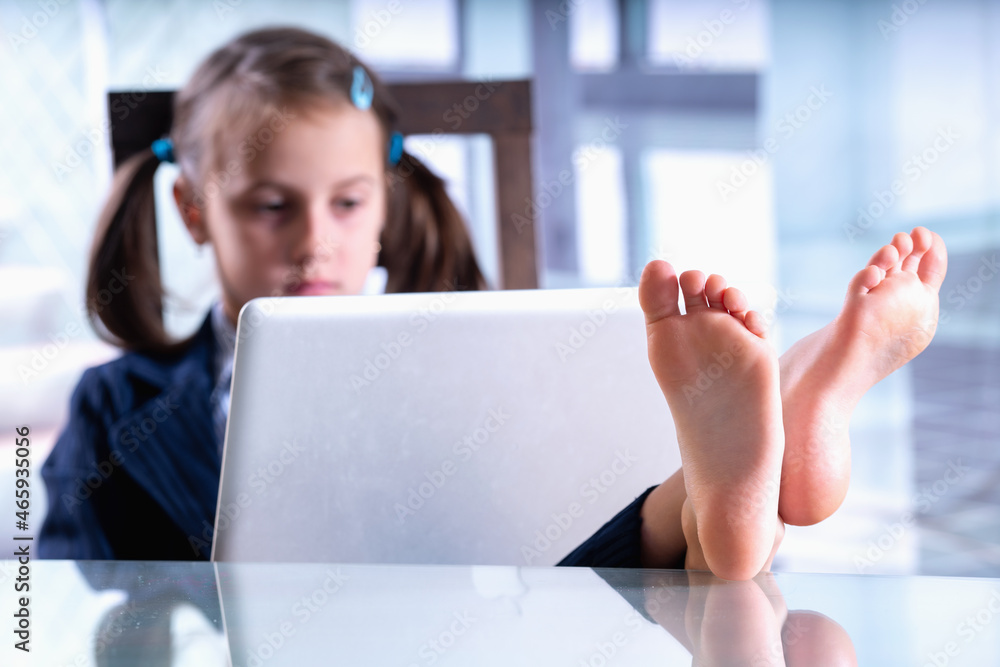 Humorous photo of employee is resting and working at the same time. Selective focus on bare feet. Humorous photo of employee is resting and working at the same time. Selective focus on bare feet.