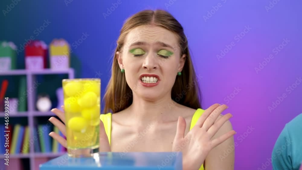 A cute girl holds a glass cup with raw eggs in her hands. A cute girl holds a glass cup with raw eggs in her hands.