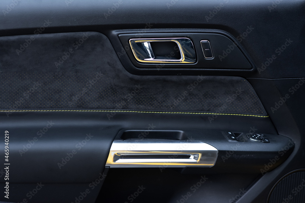 Sports car interior. Close-up Alcantara door trim. Detailing concept
