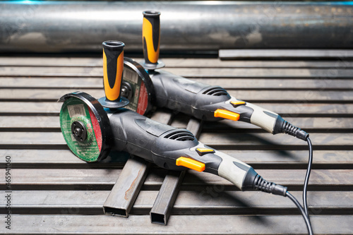 an angle grinder for cutting and grinding metal lie side by side on the working surface