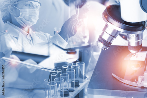Double exposure microscope Young woman scientific using equipment in the laboratory for research.Biotechnology,development,chemical,study,vaccine,COVID-19. Photo concept experimentation and research.
