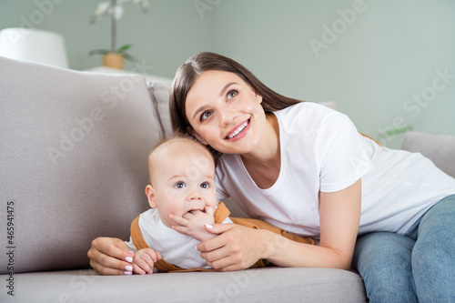 Photo of positive nice curious dreamy interested family sit couch look away wear casual outfit home indoors