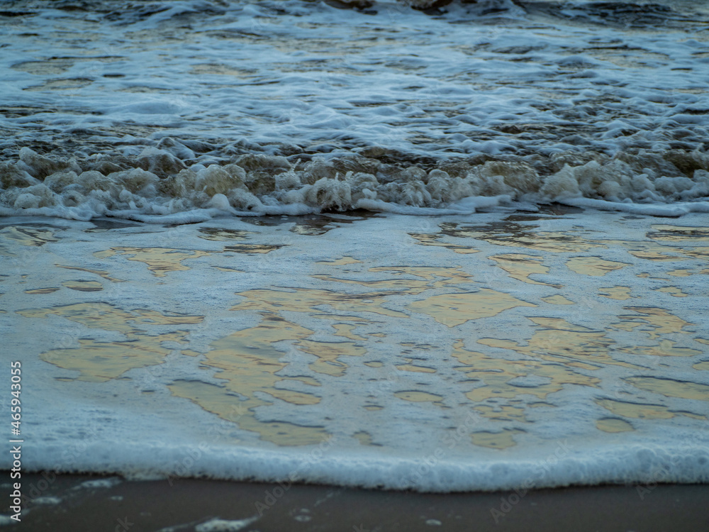 Fototapeta premium Wave with white foamy coastline beach. Sandy shore.