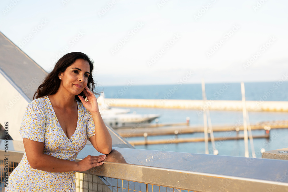 Happy young woman with a city map travelling. Young beautiful female traveler, standing on the street and looking at the map... Happy young woman with a city map travelling. Young beautiful female traveler, standing on the street and looking at the map...