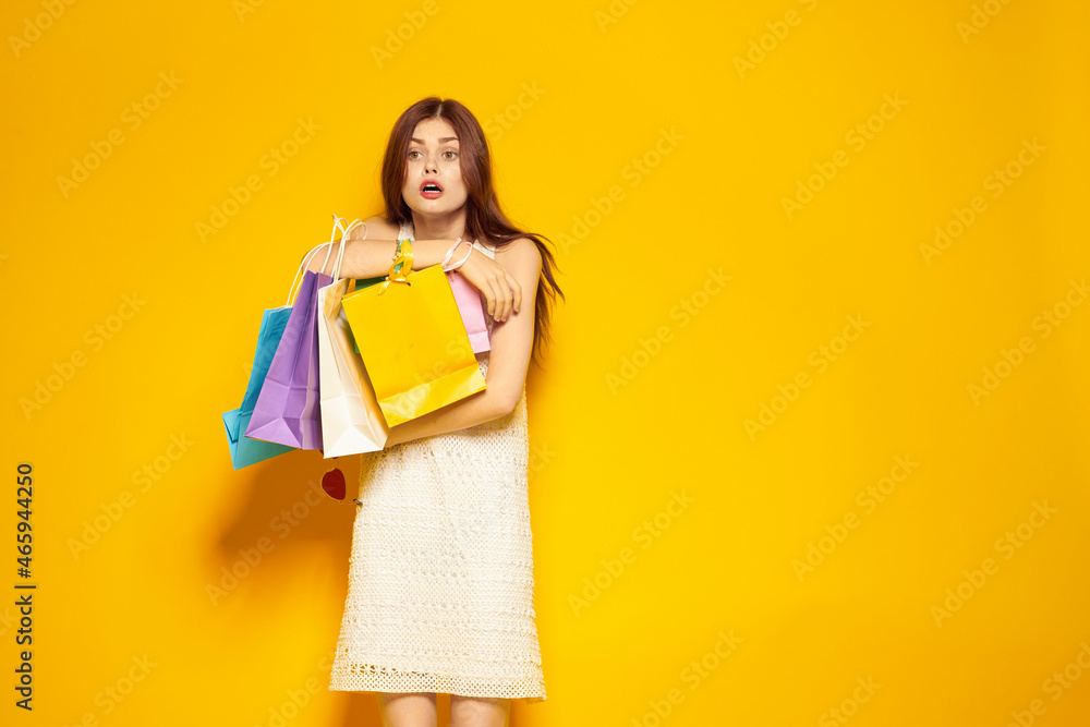 smiling woman shopping entertainment lifestyle yellow background