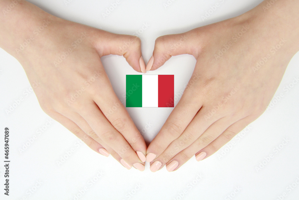 Women's hands create a heart inside the flag of Italy on a white background.Background for postcards and banners for Republic Day, Flag Day, National Unity Day, travel, patriotism.