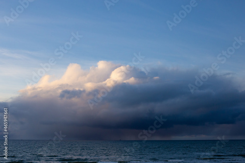 Dramatic dark blue grey yellow stormy cloudy sky and evening winter Baltic sea background photo