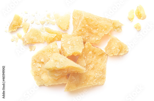 Parmesan cheese (Parmigiano, Grana) with crumbs isolated on white background. Hard mature cheese, pile, top view..