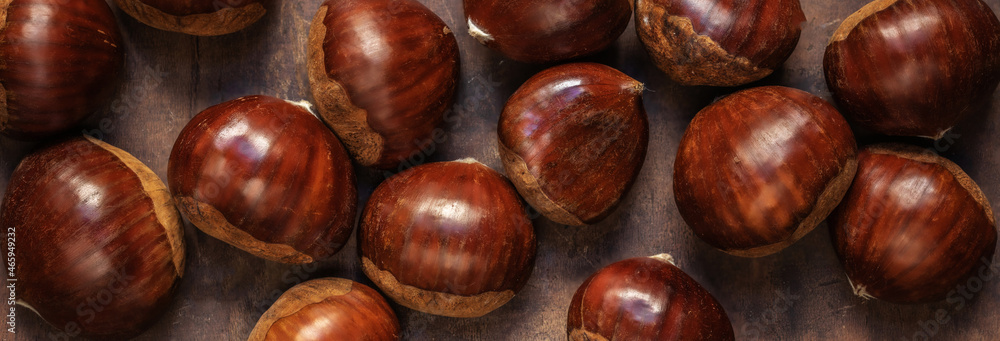 Chestnuts on on an old board with copy space. Autumn fall concept. Horse chestnuts top view. Chestnuts on on an old board with copy space. Autumn fall concept. Horse chestnuts top view.