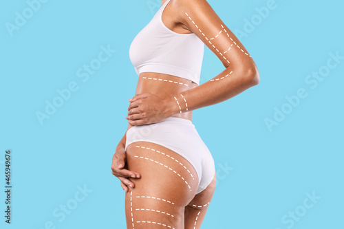 Obraz na plátně Closeup Of Woman Posing Isolated Over Blue Studio Background