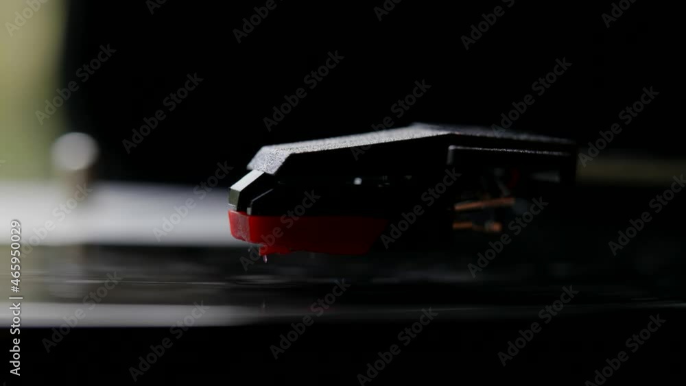 A vinyl record player. Close-up of a rotating vinyl record and a pickup needle. Analog vintage music equipment. A vinyl record player. Close-up of a rotating vinyl record and a pickup needle. Analog vintage music equipment.