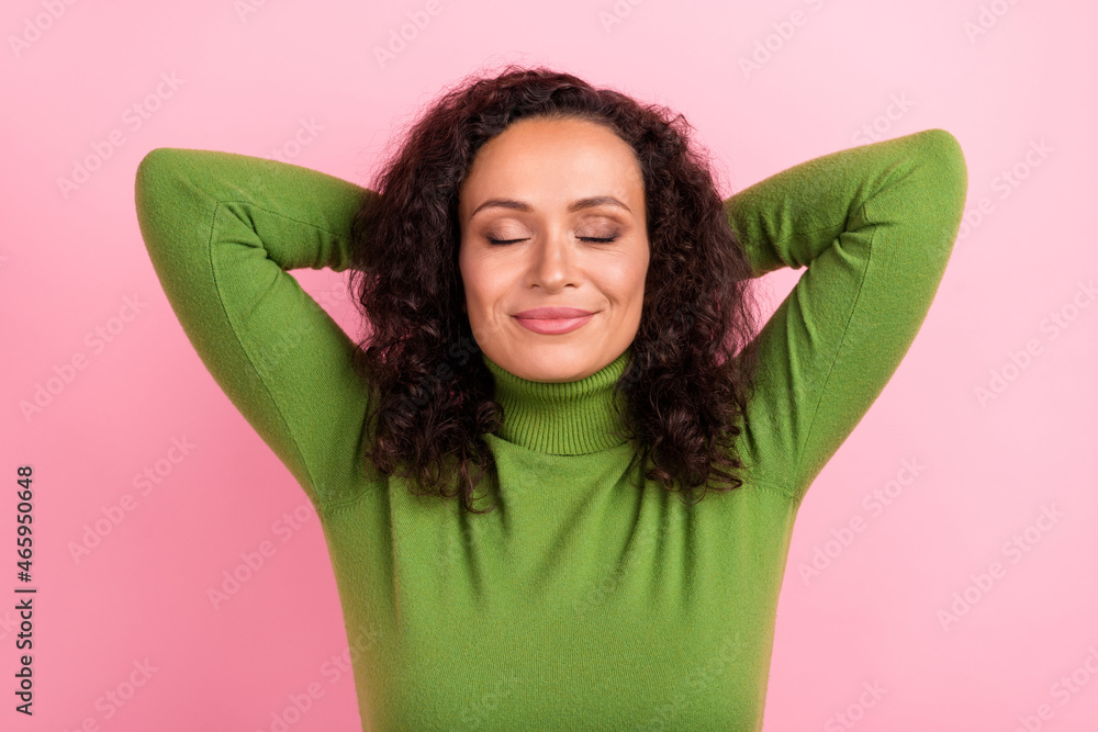 Photo of charming pretty african lady dressed green turtleneck smiling hands arms behind head closed eyes isolated pink color background Photo of charming pretty african lady dressed green turtleneck smiling hands arms behind head closed eyes isolated pink color background