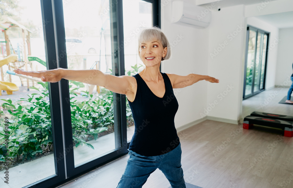 Yoga at home. Senior woman exercising indoor. Concept of healthy lifestyle. Yoga at home. Senior woman exercising indoor. Concept of healthy lifestyle.