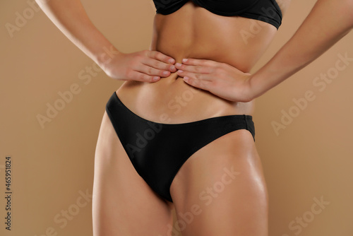 slim woman holding her thin waist with her hands