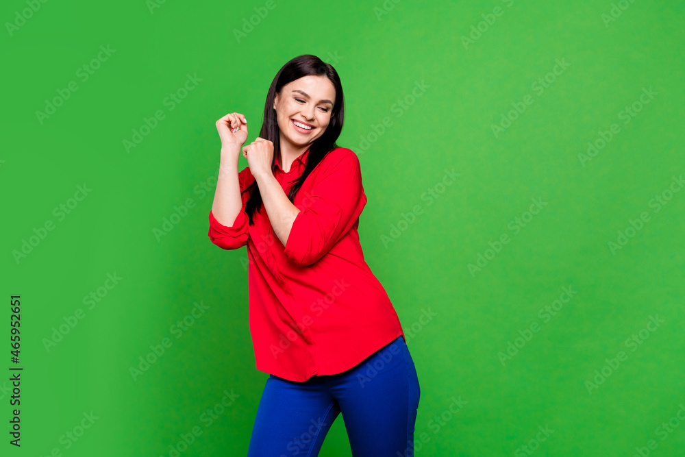 Photo of cool brunette young lady dance wear red shirt isolated on green color background Photo of cool brunette young lady dance wear red shirt isolated on green color background