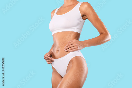 Closeup Of Unrecognizable Lady Posing Isolated On Blue Studio Background