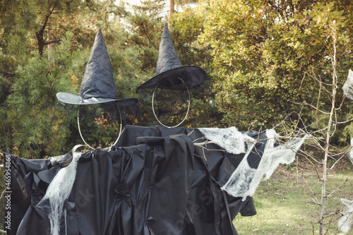Halloween witch scarecrow and spider web decoration. Yard decor and holiday photo zone ideas for party. Selective focus, copy space