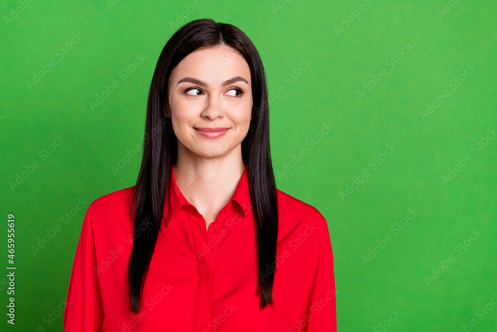 Photo of friendly brunette young lady look empty space wear red shirt isolated on green color background Photo of friendly brunette young lady look empty space wear red shirt isolated on green color background