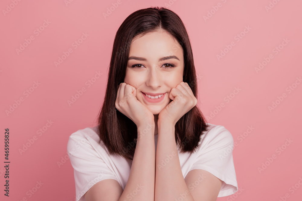 Photo of young cheerful girl hands touch cheeks dream toothy smile oral care isolated over pink color background Photo of young cheerful girl hands touch cheeks dream toothy smile oral care isolated over pink color background