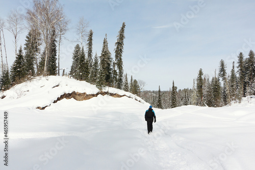 Man walking along a snowy trail, Altai Republic, Russia