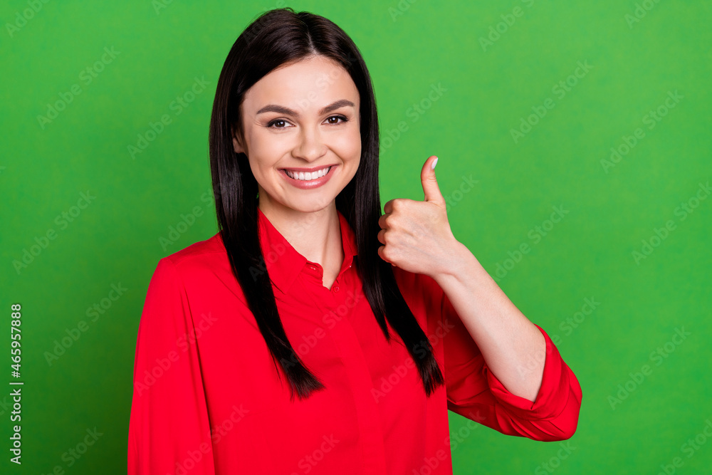 Portrait of attractive cheerful lady showing thumbup ad solution excellent isolated over bright green color background Portrait of attractive cheerful lady showing thumbup ad solution excellent isolated over bright green color background