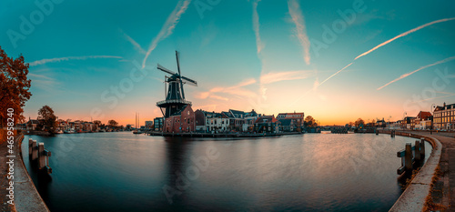 High resolution panorama image of the Adriaan windmill along the Spaarne river in Haarlem at sunrise photo