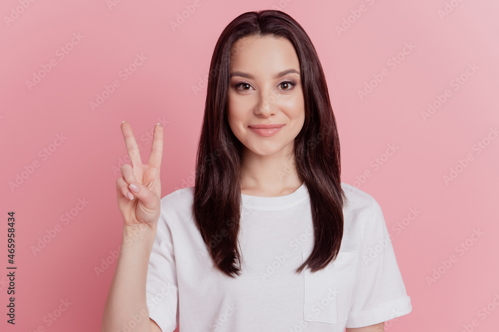 Photo of young lovely lady good mood show fingers peace cool v-symbol isolated over pink color background