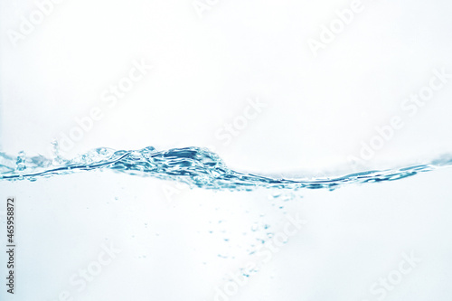 the bubbling and rippling water surface from the side view isolated on white. abstract liquid nature texture.