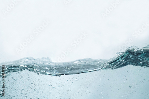 the rippling water from the side view. the water surface isolated on white. abstract liquid nature texture.