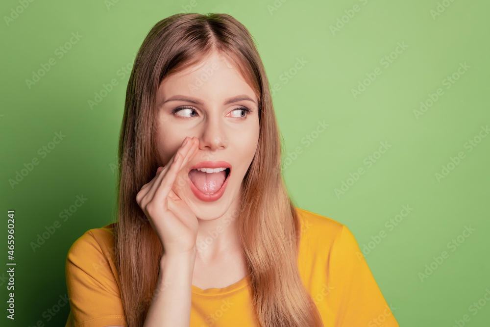Portrait of cunning lady palm open mouth look empty space wear yellow t-shirt isolated on green color background Portrait of cunning lady palm open mouth look empty space wear yellow t-shirt isolated on green color background