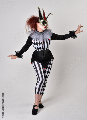  halloween, character, costume, figure pose, posing, portrait, gesture, isolated, magical, dynamic movement, isolated, studio background, red hair, circus, theatre, jester, clown, full length,