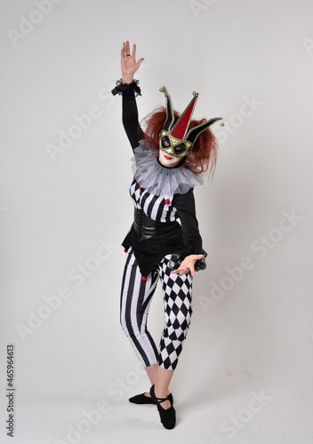  halloween, character, costume, figure pose, posing, portrait, gesture, isolated, magical, dynamic movement, isolated, studio background, red hair, circus, theatre, jester, clown, full length,