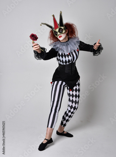  halloween, character, costume, figure pose, posing, portrait, gesture, isolated, magical, dynamic movement, isolated, studio background, red hair, circus, theatre, jester, clown, full length,