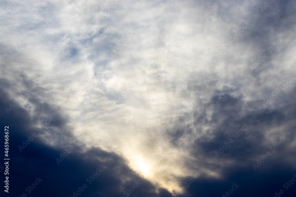 Beautiful dramatic, apocalyptic sky, cloud storm, pattern background. Sun rays through the clouds. Contrast sky. sunset