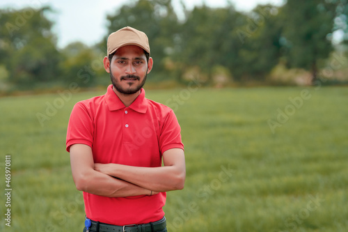 Indian agronomist giving expression with hand at agriculture field.