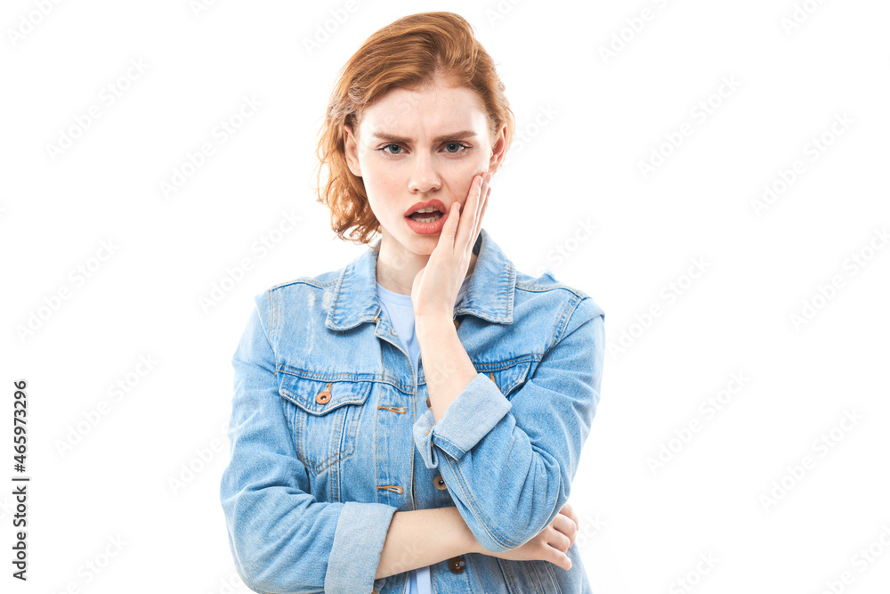 Portrait of red haired dreamy lovely lady, youth. Redhead woman in blue jeans displeased thinks, chooses, decides, dilemmas, isolated white background. Girl student is unhappy Portrait of red haired dreamy lovely lady, youth. Redhead woman in blue jeans displeased thinks, chooses, decides, dilemmas, isolated white background. Girl student is unhappy