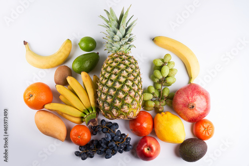 Mix of fresh juicy colorful exotic tropical fruits on white background top view
