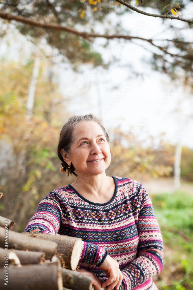 Portrait of elderly Russian woman in sweater in village
Portrait of elderly Russian woman in sweater in village