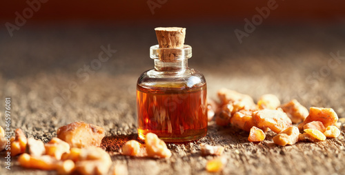 A bottle of styrax benzoin essential oil with benzoin resin photo
