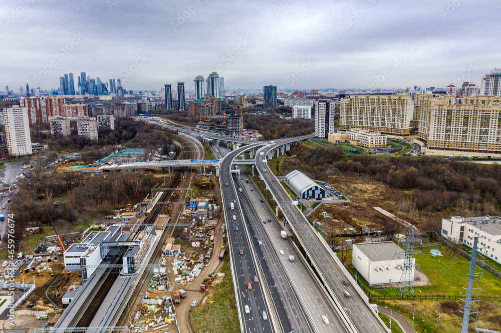 Naklejka premium cityscape with freeway in autumn day filmed from drone 
