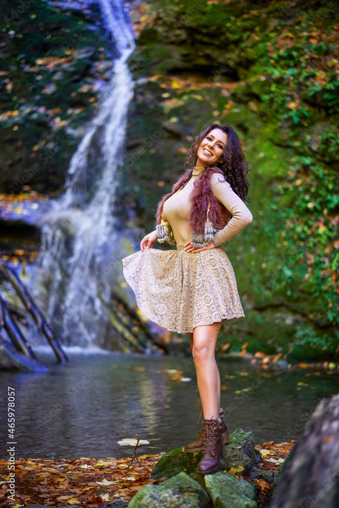 a beautiful woman sitting by a waterfall in different positions. a beautiful woman sitting by a waterfall in different positions.